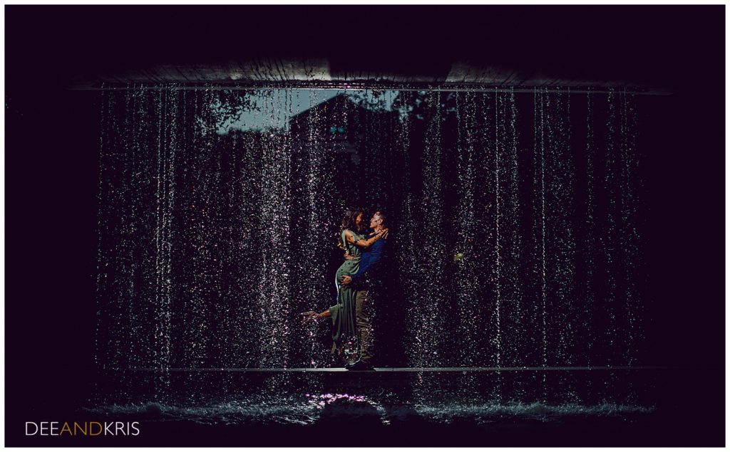 Couple poses in front of UC Davis water feature