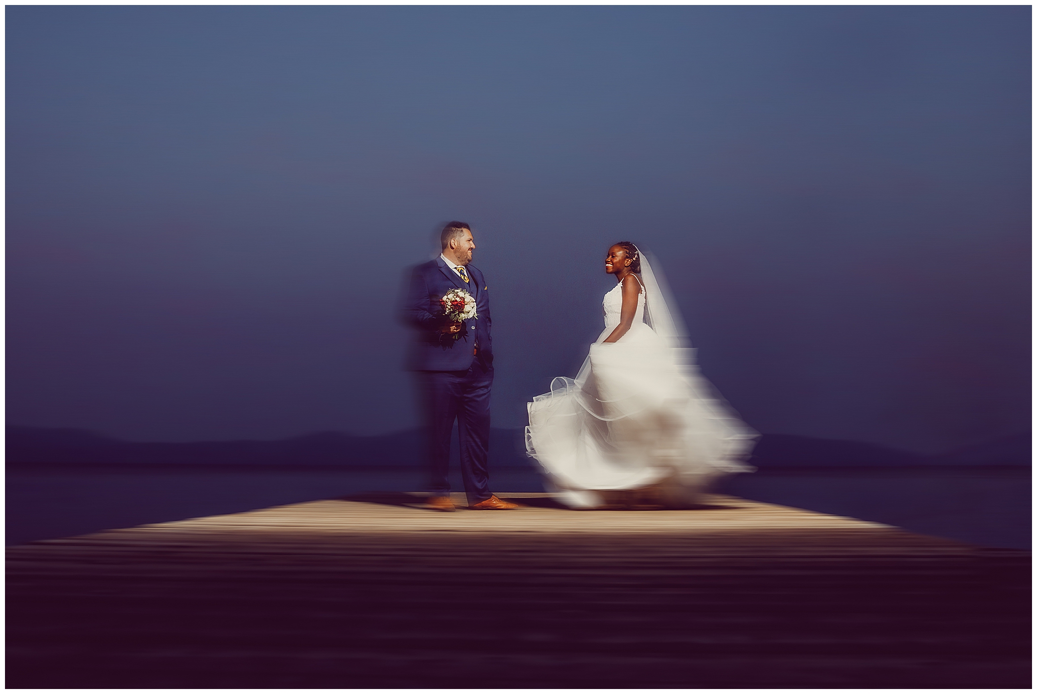 Bride dances for Groom on South Lake Tahoe Pier photographed by Dee and Kris Photography