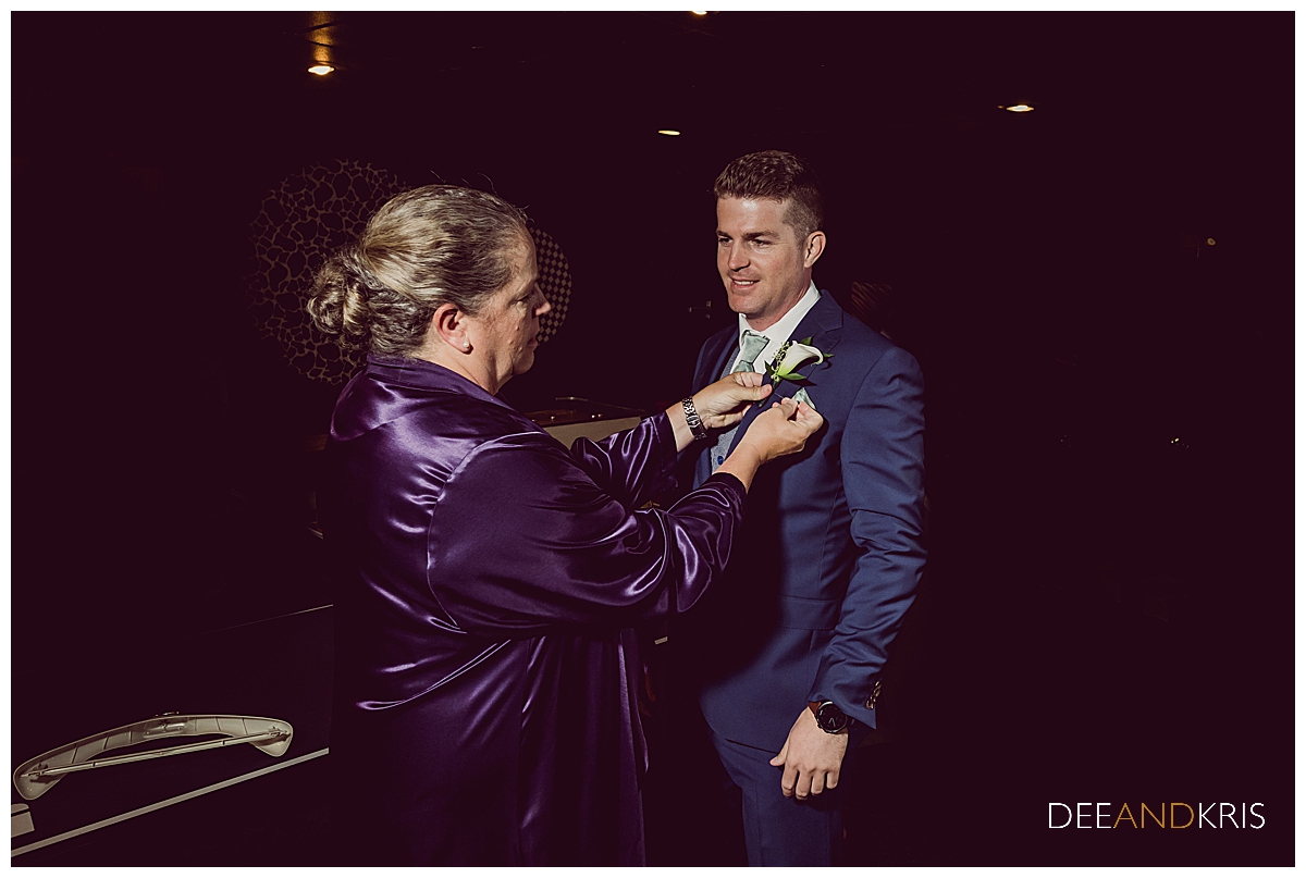 One image of the mother-of-the-groom putting on her son's boutonniere.