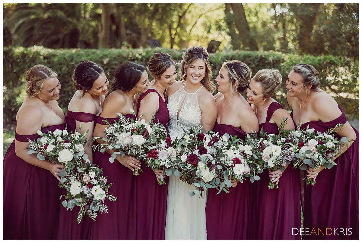One image of the bridesmaids looking at the bride in the center.