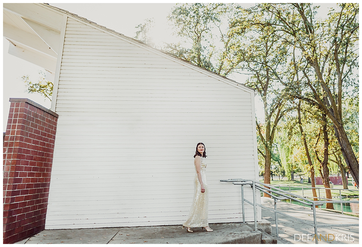 Single color image of bride against a white wall.