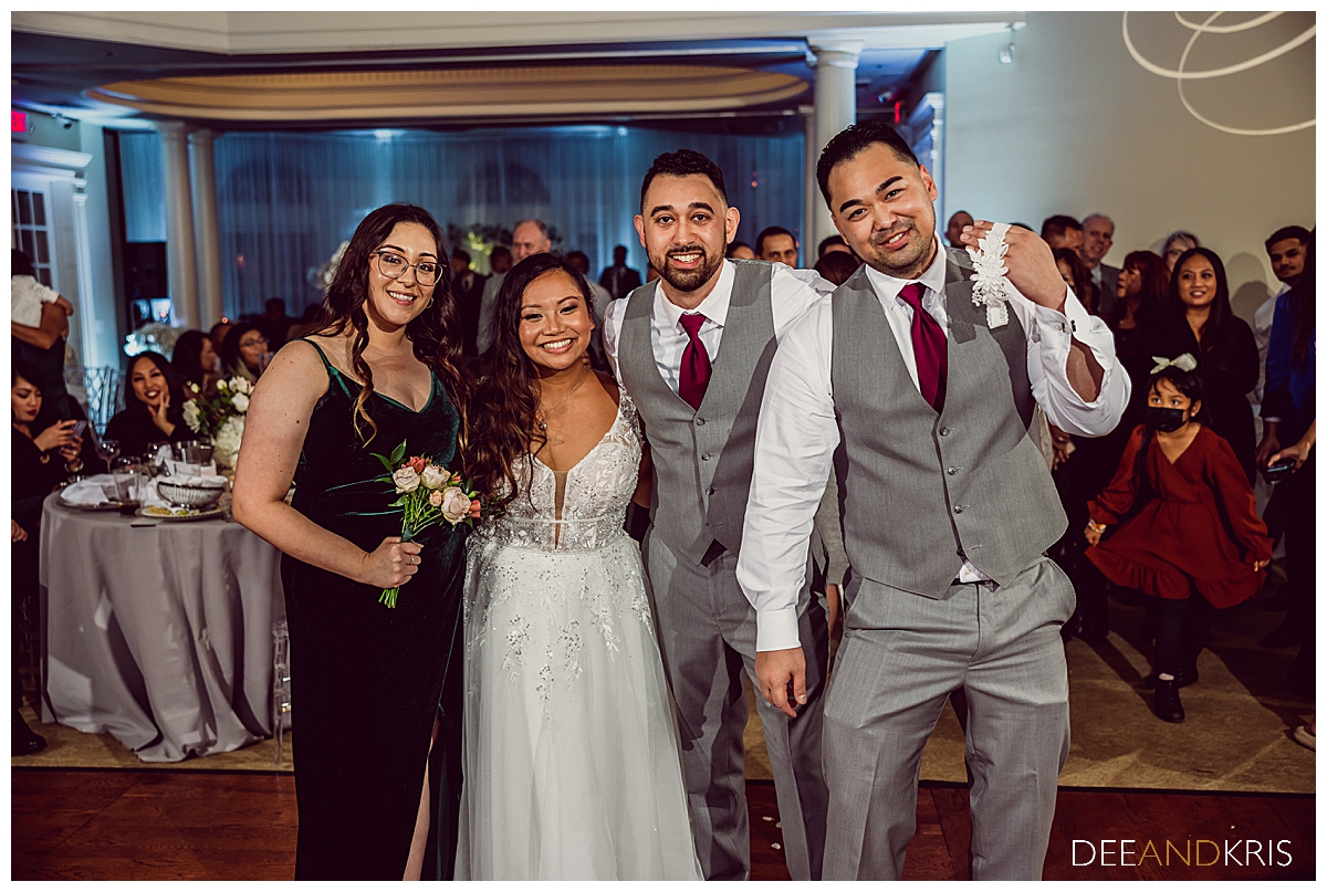 Single image of guests who caught garter and bouquet with bride and groom