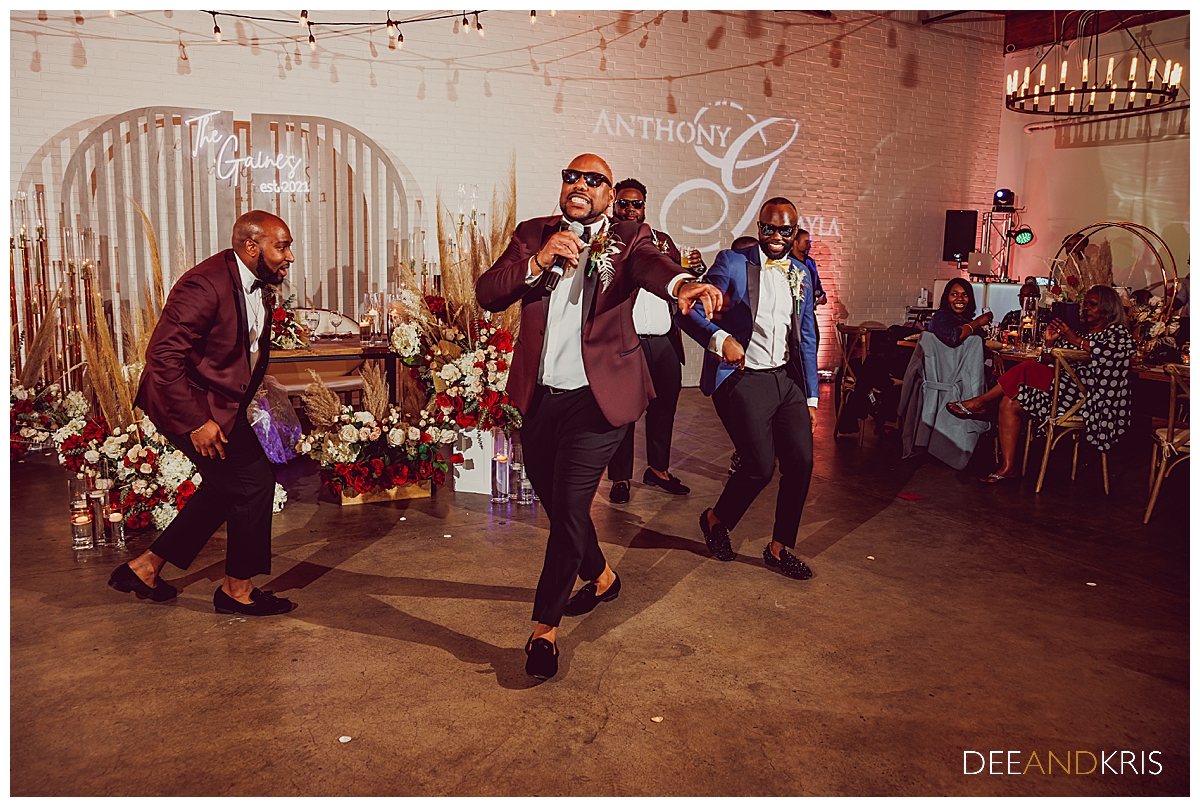 Single image of groom and groomsmen dancing.
