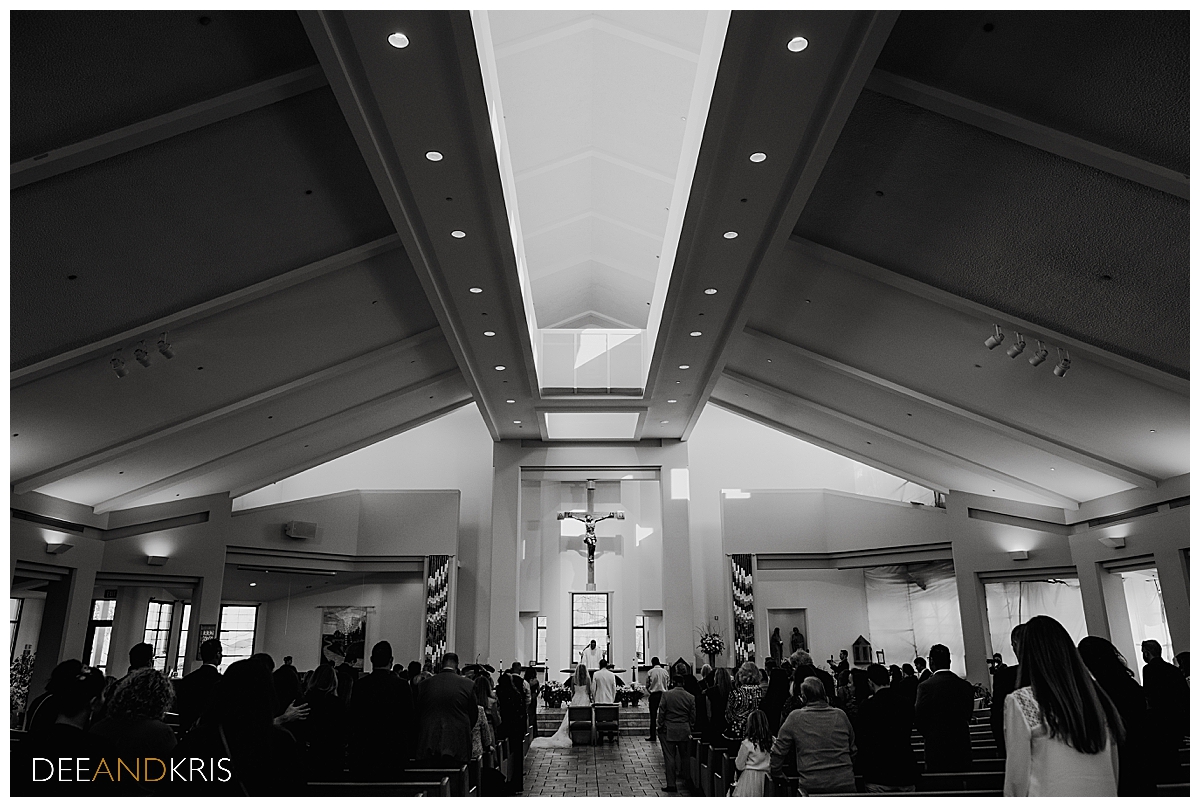 Single black and white pullback image of church ceremony.